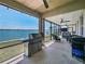 Screened back patio with grill, furniture, and water views for outdoor living and entertaining at 395 Blue Cypress Dr, Groveland, FL 34736
