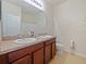 Bathroom includes dual sinks, neutral wall paint, and large vanity at 395 Blue Cypress Dr, Groveland, FL 34736