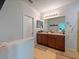 Well-lit bathroom boasts double sinks with a spacious countertop, providing ample storage and convenience at 395 Blue Cypress Dr, Groveland, FL 34736