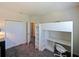 Bright bedroom featuring a modern loft bed with integrated desk and closet for storage at 395 Blue Cypress Dr, Groveland, FL 34736