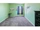 Bedroom includes a wall mounted tv, carpeted floors, and a window with blinds at 395 Blue Cypress Dr, Groveland, FL 34736