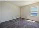 Bright bedroom with neutral walls, carpeted floors and a window with a water view at 395 Blue Cypress Dr, Groveland, FL 34736