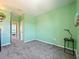 Bedroom with carpet, light green walls, ceiling fan and a view to the hallway at 395 Blue Cypress Dr, Groveland, FL 34736
