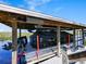 Covered boat and dock featuring a Bentley pontoon boat with a Suzuki motor at 395 Blue Cypress Dr, Groveland, FL 34736