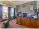 Home office features a wooden accent wall, a large window, and a spacious desk area at 395 Blue Cypress Dr, Groveland, FL 34736