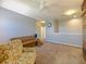 Living room with large sofa, patterned chair and carpeted floor at 395 Blue Cypress Dr, Groveland, FL 34736