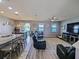 Open-concept living room with views of the water, features wood floors and modern furnishings at 395 Blue Cypress Dr, Groveland, FL 34736
