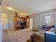 Living room with neutral paint, carpet, and built-in shelves at 395 Blue Cypress Dr, Groveland, FL 34736