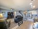 Open-concept living space features a kitchen island and a clear view of the living room and staircase at 395 Blue Cypress Dr, Groveland, FL 34736