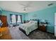 Spacious primary bedroom features carpeted floors, light blue walls and ceiling fan at 395 Blue Cypress Dr, Groveland, FL 34736