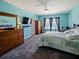 Bright primary bedroom features an ensuite bathroom, closet, and window views at 395 Blue Cypress Dr, Groveland, FL 34736