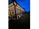 Atmospheric screened-in patio with string lights and comfortable seating, creating a cozy space for relaxing at night at 395 Blue Cypress Dr, Groveland, FL 34736