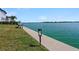 Lake view from a dock with seating. Enjoy a calm morning or afternoon watching the water at 395 Blue Cypress Dr, Groveland, FL 34736