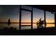 Stunning waterfront view from screened patio, offering picturesque sunsets and a tranquil setting at 395 Blue Cypress Dr, Groveland, FL 34736