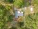 Aerial view of a single story home, surrounded by a lush tree canopy at 4123 County Road 124, Wildwood, FL 34785