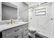 Updated bathroom with marble vanity, glass shower with gold fixtures, and modern toilet at 4123 County Road 124, Wildwood, FL 34785