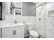 Bright bathroom with marble-patterned tiling, modern fixtures, and walk-in glass shower at 4123 County Road 124, Wildwood, FL 34785
