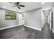 Spacious bedroom features a ceiling fan, natural light, and attractive gray wood flooring at 4123 County Road 124, Wildwood, FL 34785