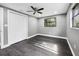 Bright bedroom with wood-look flooring, closet, ceiling fan, and a window for natural light at 4123 County Road 124, Wildwood, FL 34785