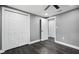 Bedroom featuring wood-look flooring, neutral walls, closet and additional doors at 4123 County Road 124, Wildwood, FL 34785