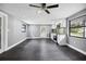 Bright living area open to a modern kitchen, featuring a large window, dark floors, and modern appliances at 4123 County Road 124, Wildwood, FL 34785