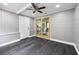 View of porch with wood paneled walls, ceiling fan, sliding glass door, and access to kitchen at 4123 County Road 124, Wildwood, FL 34785
