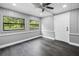Enclosed porch featuring wood paneling, ceiling fan, and access to the outdoors at 4123 County Road 124, Wildwood, FL 34785