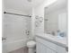 Clean bathroom features a shower-tub combo, vanity, and ample lighting for a refreshing experience at 4713 Sw 86 Ln, Ocala, FL 34476
