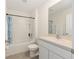 Bathroom with a tub and shower, a white vanity, and neutral gray tile flooring at 4713 Sw 86 Ln, Ocala, FL 34476