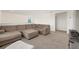 Cozy upstairs living room boasting a large sectional, ottoman, and plush carpeting for ultimate relaxation at 4713 Sw 86 Ln, Ocala, FL 34476