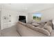Comfortable upstairs living room featuring a large sectional sofa and a bright window overlooking the lawn at 4713 Sw 86 Ln, Ocala, FL 34476