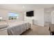 Inviting main bedroom featuring neutral carpeting, a large window, and sleek furnishings for a relaxing retreat at 4713 Sw 86 Ln, Ocala, FL 34476