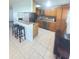 Spacious kitchen with breakfast bar, stainless steel appliances, and ample cabinet space at 48 Pinehurst Cir, Ormond Beach, FL 32174