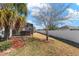 Wide backyard featuring a screened-in lanai and lawn at 4987 Belted Kingfisher Dr, Oxford, FL 34484