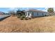 Backyard with lawn and view of the enclosed back lanai at 4987 Belted Kingfisher Dr, Oxford, FL 34484