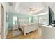 A bright bedroom with a white bed frame, hardwood floors, and plenty of natural light at 4987 Belted Kingfisher Dr, Oxford, FL 34484