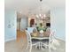 Dining area with natural light, a modern chandelier, and easy access to kitchen and living room at 4987 Belted Kingfisher Dr, Oxford, FL 34484