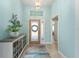 Elegant foyer with tile flooring, decorative console, and view of the home's interior at 4987 Belted Kingfisher Dr, Oxford, FL 34484
