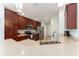 Well-equipped kitchen with stainless steel appliances, dark cabinets, and a sink beneath recessed lights at 4987 Belted Kingfisher Dr, Oxford, FL 34484