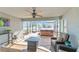Enclosed lanai featuring a ceiling fan, tiled flooring, hot tub, and comfortable seating at 4987 Belted Kingfisher Dr, Oxford, FL 34484