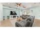 Inviting living room with tile flooring, ceiling fans, and cozy fireplace feature at 4987 Belted Kingfisher Dr, Oxford, FL 34484