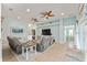 Spacious living room with tile floors, ceiling fans, and an open layout at 4987 Belted Kingfisher Dr, Oxford, FL 34484