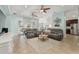 Comfortable living room with tile floors, ceiling fans, and view of the screened patio at 4987 Belted Kingfisher Dr, Oxford, FL 34484