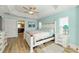 Comfortable bedroom featuring a bed, ensuite bathroom, and light-filled windows at 4987 Belted Kingfisher Dr, Oxford, FL 34484