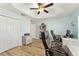 Bright home office with hardwood floors, ceiling fan, and dual workstation setup at 4987 Belted Kingfisher Dr, Oxford, FL 34484