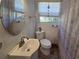 Bathroom featuring a single sink vanity, window and flamingo shower curtain at 504 Se 35Th Ave, Ocala, FL 34471