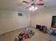 This bedroom features tile flooring and a ceiling fan, offering comfort and functionality at 504 Se 35Th Ave, Ocala, FL 34471