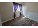 Bright bedroom with wood-look floors, blue anchor curtains, and a white door for a neat look at 504 Se 35Th Ave, Ocala, FL 34471
