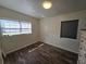 Bright bedroom with a light fixture, wood-look floors, two windows, and a chest of drawers at 504 Se 35Th Ave, Ocala, FL 34471