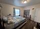 This bedroom boasts wood-look flooring, a closet, and light from the window for a bright comfortable space at 504 Se 35Th Ave, Ocala, FL 34471